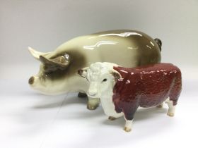 A Beswick figure of a Herefordshire bull and a cer
