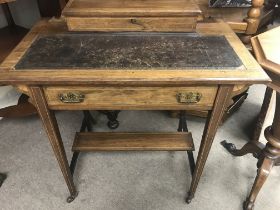 A Edwardian mahogany desk the rectangle top above a single drawer on tapering legs .