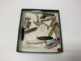 A box containing vintage miniature pen knives.