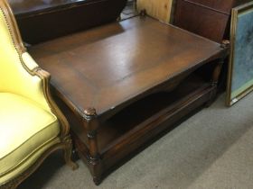 A two tier table with leather top, approx width 10