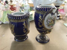 Two 19th century sevres porcelain vases decorated with flowers and foliage in guilt. Restoration