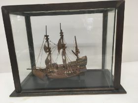 A model sailing ship in a glass case.40x33cm
