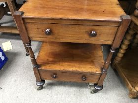 A Victorian side table fitted with two drawers on turned legs .