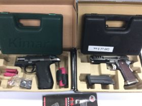 Two air guns with retail boxes and carry cases. Shipping category D.