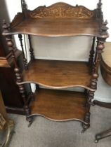 A Victorian mahogany inlaid what not with three tiers on turned surports .