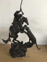 A broze figure group in the form of a Indian ridin