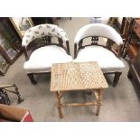 A pair of Edwardian tub chairs on caster feet, (66cm tall) and a small wicker/ bamboo table