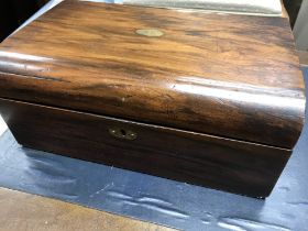 A Victorian walnut writing box the hinged lid with a fitted interior.