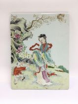 An Oriental ceramic tile with handpainted decorati