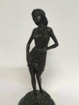 A bronzed figure in the form of a maiden on marble