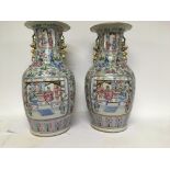 A pair of Chinese Famille Rose vases decorated wit