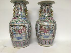 A pair of Chinese Famille Rose vases decorated wit