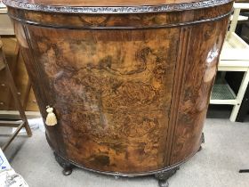 A walnut side cabinet the single door enclosing selfs .