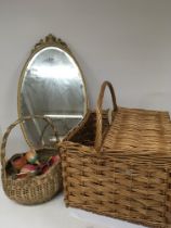 A basket containing vintage painted wood Chinese toys a picnic basket and a gilt mirror.