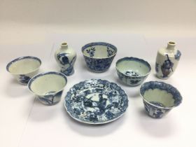 A small collection of blue and white tea bowls and