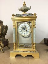 A french 19th century 4 glass guilt mantle clock with enamel inlay and ceramics mounts. With visible