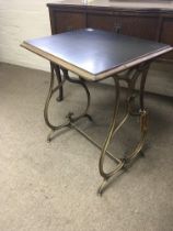 A Victorian occasional table with shaped cast iron