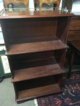 A Mahogany open bookcase with three quarter brass