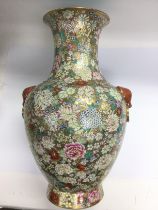 A large hand painted vase with heavy floral decora