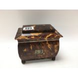 A tortoiseshell tea caddy with hinge lid enclosing 2 compartments. On brass circler feet. 15cm x