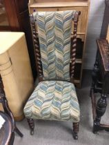 A Victorian walnut prayer chair with a high back a