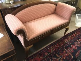 A Mahogany window seat with pink upholstery. Dimen