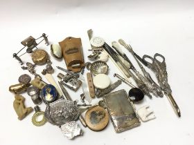 A collection of silver and other oddments including a pair of grape scissors , thimbles, watch keys,