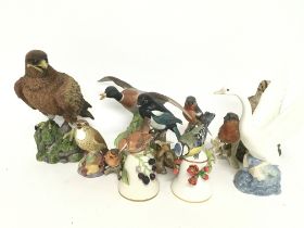 A collection of ceramic bird ornaments including R