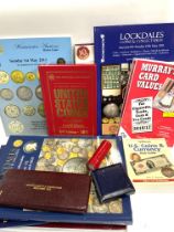 A collection of coin related books and auction magazines.
