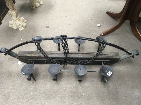 A wrought iron ceiling candle holder.