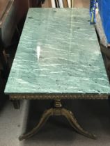 A gilt metal coffee table with a green marble top,