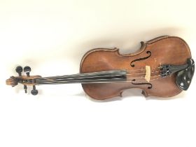 A cased student violin , 57cm long. Postage catego