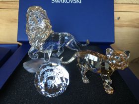 Three boxed Swarovski items including Male Lion Fi