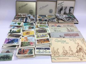 A collection of cigarette cards and vintage postca