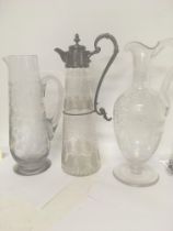 A glass claret jug with silver plated mounts and e