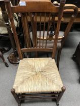 A elm stick back rocking chair with rush seat