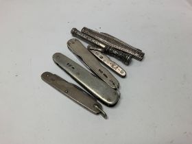 Five silver pen knives and a pencil.