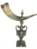 A Horn snuff mull on a heavy bronze urn shaped bas