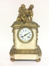 A mid 19th century French marble and ormolu clock with a mounted figure group of children and floral