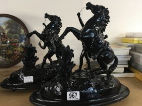 A pair of black painted spelter marley horses 34 c