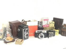 A collection of vintage cameras including Rollop,