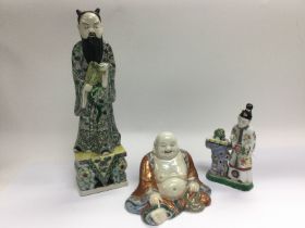 Three Oriental ceramic figures comprising a buddha