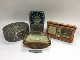 An Arts & Crafts style pewter clock, vintage folding alarm clock, penknife etc. Shipping category