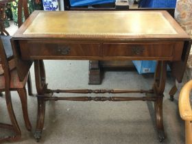 A Mahogany drop leaf writing desk with a leather top and two drawers. Dimensions 50x94x74cm