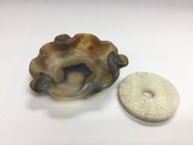 A jade dish, approx diameter 9cm, plus a jade disc