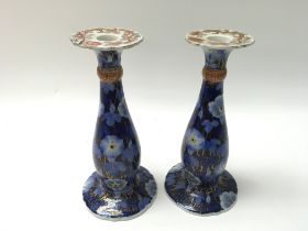 A pair of Japanese candle stick holders. One with