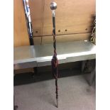 A silvered ball ended ebony staff, approximately 1