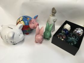A collection of paper weights, a Nao figure, two ceramic piggy money boxes, slyvac rabbits.