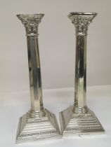 A pair of silver candle sticks Corinthian column w