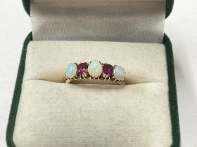A 15ct ruby and Opal set ring, 2.9g. Size N. Posta